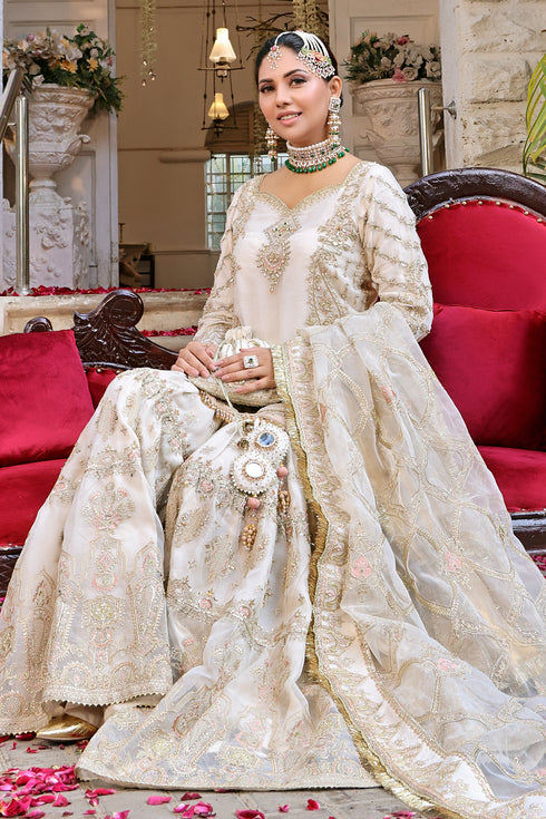 Close-up of sleeve cuff highlighting scalloped hem, mirror accents and tassel hangings on Naqshi Zonar organza shirt.